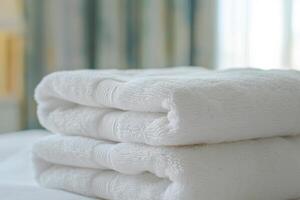 A stack of white towels on a bed photo