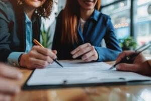 Three business people signing a contract photo