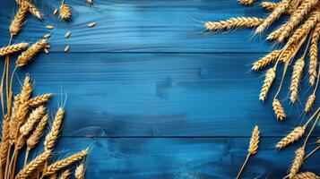 Wheat ears on blue wooden background photo
