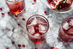 Three glasses of pomegranate juice with ice photo