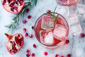 A glass of pomegranate juice with ice and rosemary photo