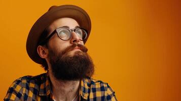 A man with a beard and glasses wearing a hat photo