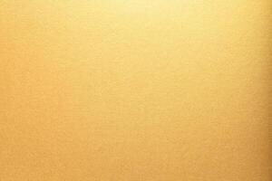 Gold paper with a smooth, glossy texture and bright, glowing gradient. The shining metallic surface photo