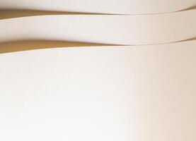 Beige paper with a pastel, neutral texture and smooth surface. Layered folds and geometric lines photo