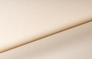 Beige paper with a smooth texture and layered folds. The neutral surface exudes a chic, classy photo