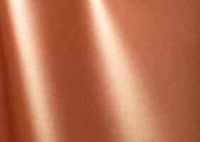 Copper metallic surface with a reflective, smooth texture and glossy sheen. Elegant and modern photo