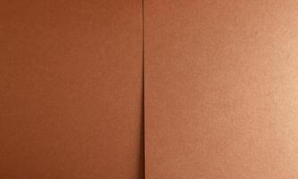 Copper texture close-up. Folded material with metallic surface, abstract pattern, and decorative photo
