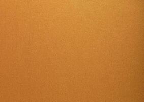 Gold paper with a glossy, metallic texture featuring soft, smooth surfaces in brass and bronze tones photo