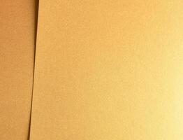 Golden metallic paper with a rich, glossy texture and shiny surface. The elegant, layered design photo