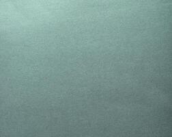 A glowing, shiny teal gradient paper with chic reflections and a glossy, smooth surface. The photo