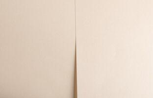 Beige paper texture with smooth folds and neutral tones. Layered lines and soft shadows create a photo
