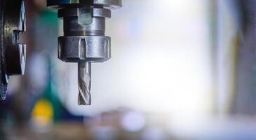 Detail of vertical drilling machine in factory workshop. photo