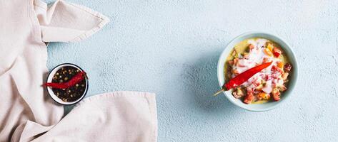 Traditional vegetable salsa with yogurt in a bowl on the table top view web banner photo