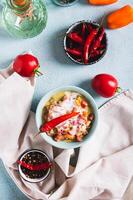 Traditional vegetable salsa with yogurt in a bowl on the table top and vertical view photo