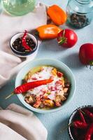 Traditional vegetable salsa with yogurt in a bowl on the table vertical view photo