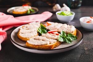 Crab stick and cucumber pate on toast on a plate on the table photo