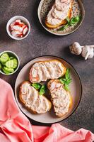 Delicious sandwiches with crab meat and cucumber pate on a plate top and vertical view photo