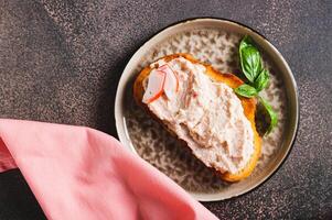 Close up os crab stick and cucumber pate on toast on a plate on the table vertical view photo