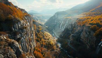 Mountain valley with waterfalls, autumn background wallpaper backdrop. Rivers, cliffs, rocky terrain walls, winding road photo