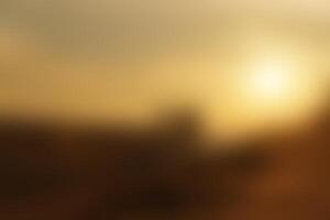 Blurred image of the morning or evening sunlight on a golden sky, representing tranquility and nature photo