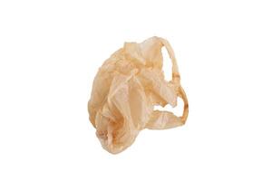 Crumpled beige plastic bag isolated on white background, perfect for concepts on pollution, recycling, and waste management photo