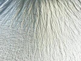 Detailed view of crumpled fabric texture, perfect for showcasing textile design, material backgrounds, and abstract patterns photo