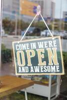Charming Open Sign Inviting All Customers to Enter and Experience Pure Awesomeness photo