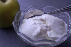 Delicious Fresh Yogurt Accompanied by Artistically Arranged Green Apple Slices on a Gray Background photo
