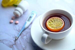 Savor warm herbal tea with lemon on a beautiful marble surface for an enhanced experience photo