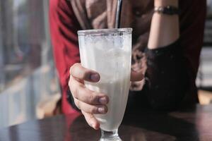 A Refreshing Milkshake, Perfectly Blended and Served in a Tall Glass for Enjoyment photo