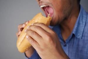A CloseUp Image of a Person Enjoying and Eating a Delicious Sandwich with Delightful Ingredients photo