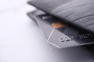 A detailed closeup view of numerous Credit Cards neatly arranged in a stylish Black Wallet photo