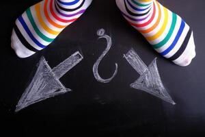 Vibrant and Colorful Striped Socks Featuring Directional Arrows and an Intriguing Question Mark photo
