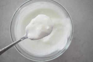 fresh yogurt in a bowl on table photo