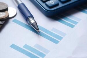 Various Financial Analysis Tools Including a Calculator, Pen, Coins, and Graph Paper photo