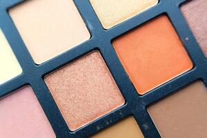 A CloseUp View of a Colorful Eyeshadow Palette Showcasing Various Warm Tones and Hues photo