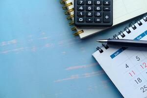 Features a Calculator, Notepad, and Calendar positioned on a Teal Background suitable for Planning photo