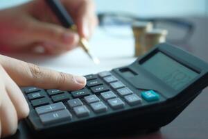 A person is utilizing a calculator to perform essential financial calculations for their work photo