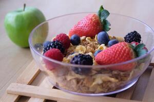 A nutritious and delicious Healthy Breakfast Bowl featuring fresh Berries and slices of Apple photo