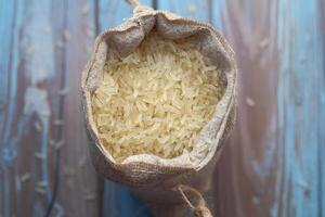 An Aerial Perspective View of a Burlap Sack That Is Completely Filled with Raw Rice Grains photo