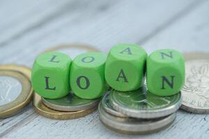 The concept of loans is symbolized by coins and green dice reflecting financial dynamics photo