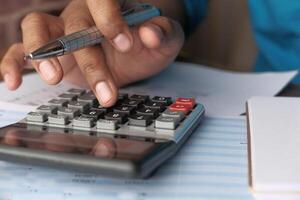 A person is diligently using a calculator for various financial calculations and planning purposes photo