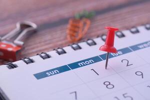 A Colorful Calendar adorned with a Red Pin to Mark Important Dates and Deadlines Precisely photo