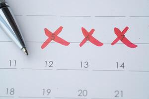 A calendar featuring numerous dates crossed out with a pen can help in planning effectively photo