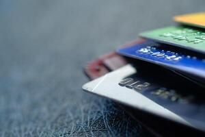 A Stack of Various Credit Cards Arranged Neatly on a Textured Background Surface photo