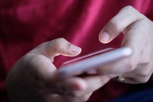 A closeup shows hands with a smartphone in soft lighting, highlighting usertech connection photo