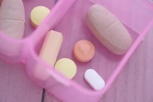 A collection of assorted dietary supplements neatly arranged in a handy pill organizer photo