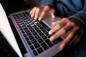 A person typing on a laptop in a professional setting, displaying focus and creativity photo