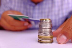 A Visual Representation of a Stack of Coins along with a Credit Card Payment Concept photo
