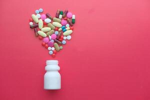A Heart Shape Formed with a Variety of Colorful Pills and Dietary Supplements of Health photo